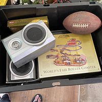 Overall view showing football, speakers, boxed Christmas coaster, golf balls in tote