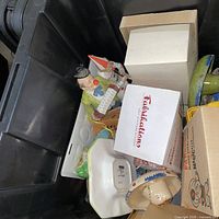 Overview of bin with clown figurine, Funko box and assorted boxed items