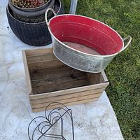 All four garden decor pieces together: galvanized tub, wood crate, woven planter, wire heart basket