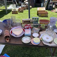 overall view of table showing glassware, plates, planters, candles