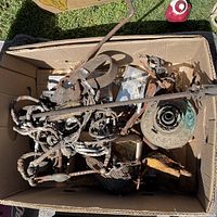 Top view of box showing mixed rusty iron pieces, chain, hooks, green patina canopy