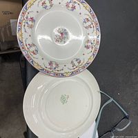 Top view of rimmed soup bowl and dinner plate showing pattern and crazing