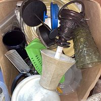 Box containing assorted kitchen tools, utensils, green glass tumbler and small lamp parts