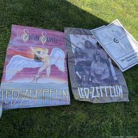All three posters laid out on grass