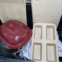 Overall lot showing covered baker lid, loaf pan, mixing bowls