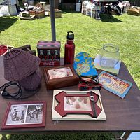 Overall lot view showing lamp, water bottle, frames, book