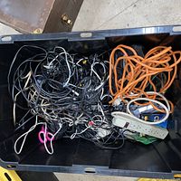 overview of tote filled with assorted cords and power strips