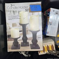 Boxed 3-piece candle holder set visible in bin