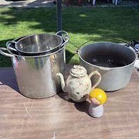 All cookware, teapot and Avon bottle on table