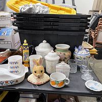 Overview of lot showing bunny figurine, carrot mug, bowls, casserole dish, canisters, glass canister, pitcher and other pieces