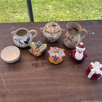 All items on table: teapot, pitcher, creamer, bowl, two shaker sets