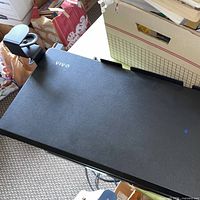Keyboard tray attached to desk edge showing V.I.V logo and clamp mechanism