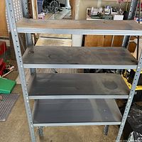 Front view of 4-tier metal shelving showing overall structure and shelf surfaces