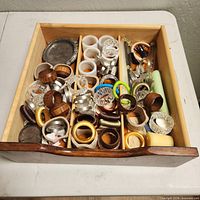 Full drawer view showing quantity and variety of napkin rings and coasters
