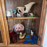 Cabinet with upper and lower shelves showing majority of items