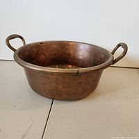 Exterior view of copper pot showing both side handles and general patina