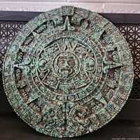 Front view of Aztec calendar plaque showing full design and patina finish