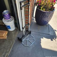 Hand cart unfolded showing platform, handle extended