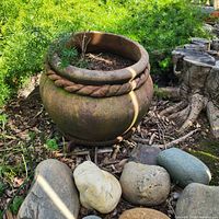 Front view of terracotta urn planter in garden