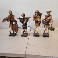 All four EB paper mache worker figurines on bases