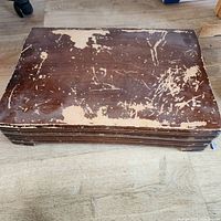 Worn brown storage case closed