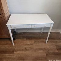 front view of white desk showing drawers and legs