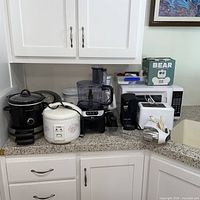 Overview showing slow cooker, rice cooker, Ninja food processor, single-serve coffee maker, hand mixer