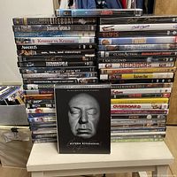 Overall view of stacked DVDs with Hitchcock box set showcased