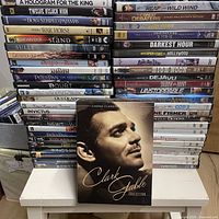 Two tall stacks of DVD cases with Clark Gable Collection displayed in front