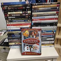 Two stacks of DVD movies with holiday set in foreground