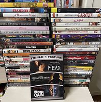 Front view showing three stacks of DVDs and a triple-feature case