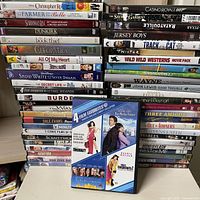 Two tall stacks of DVD cases on tabletop showing majority of titles