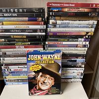 Two stacks of DVDs with John Wayne box in front