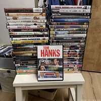 Full view of two tall DVD stacks with Tom Hanks 3-Movie Collection in foreground