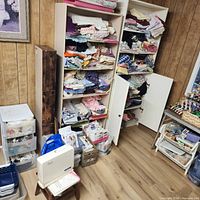 overall view showing bookcases filled with fabric, drawer units and supplies
