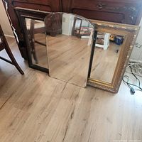 Three mirrors: wood-framed, frameless arched, gilt ornate