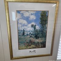 Vertical framed Monet landscape print, gold frame and mat visible