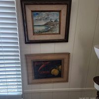 Both framed artworks on wall, showing relative size and frames