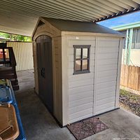 front and side view of shed under carport