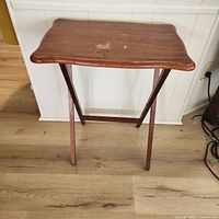 Front view of wooden folding tray table standing open