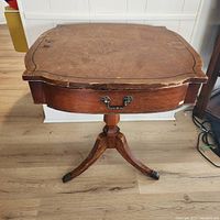 Full view of drum side table showing drawer, pedestal and legs
