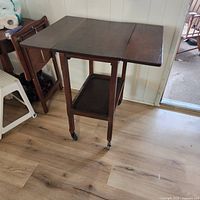 Cart with both leaves raised showing full tabletop and lower shelf