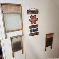 Both washboards and hanging sign displayed on wall