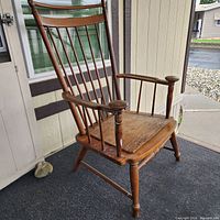 Front view of high-back wooden Windsor armchair