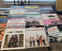 Overhead view showing full assortment of vinyl LP records laid out on table