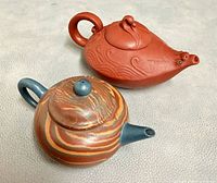 Top view of both clay teapots showing shapes, colors and handles