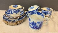 Front view showing plates, teacups, saucers and mugs