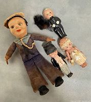 Group shot of all four dolls displaying relative sizes and outfits