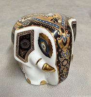 Left front view showing ornate decorative pattern and elephant form