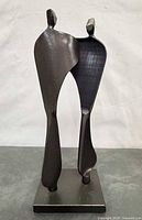 Front view of forged steel abstract sculpture on base